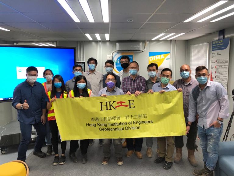 Group of engineers holding HKIE Geotechnical Division banner indoors