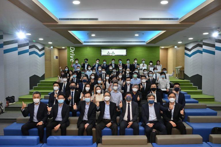 People in auditorium giving thumbs up