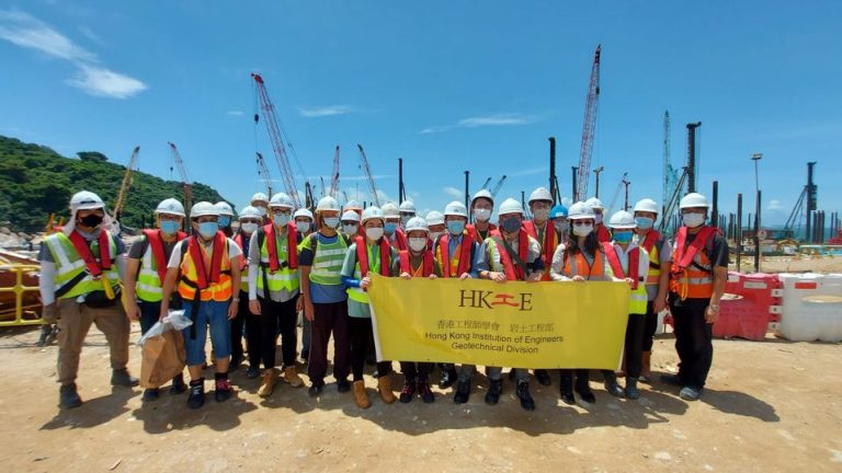 Engineers holding banner at site