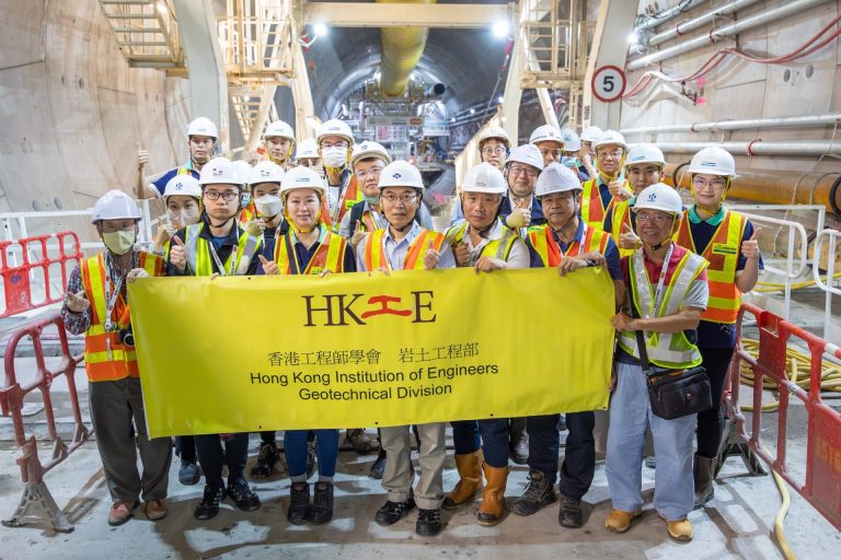 Engineers holding banner at site