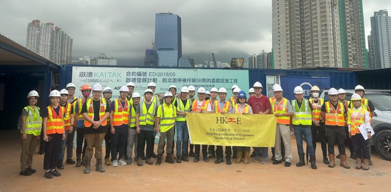 Engineers with banner at site
