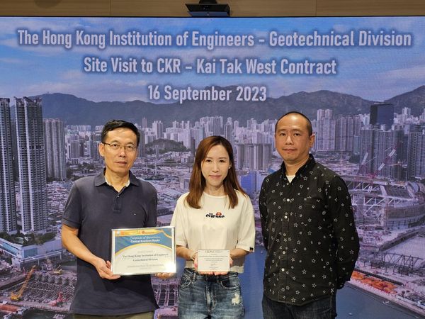 Three people holding certificates at a geotechnical engineering site visit in Hong Kong.