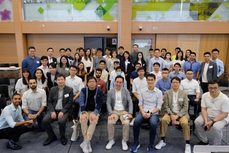 Group photo of attendees at a professional event, smiling for the camera.
