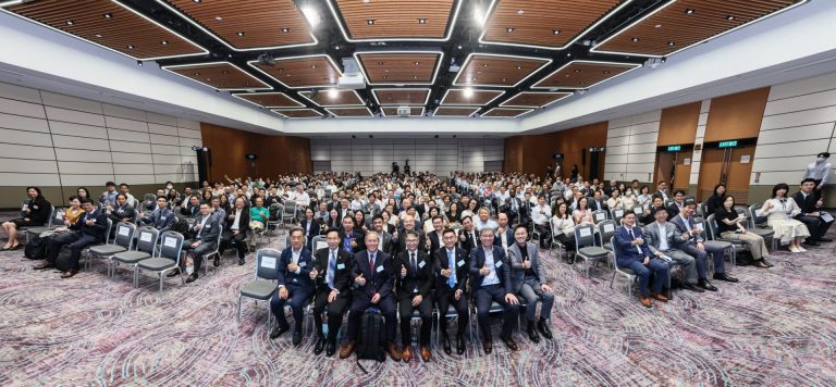 Group of attendees giving thumbs up at a conference event