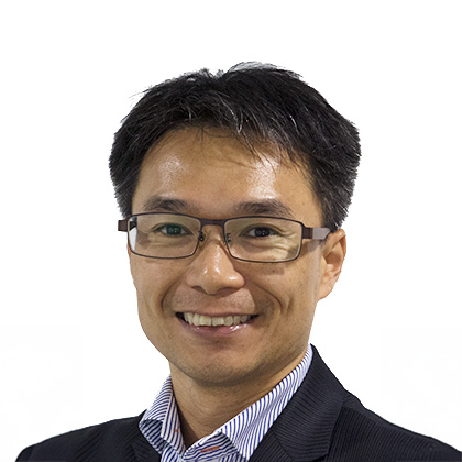 Smiling man with glasses wearing suit and striped shirt