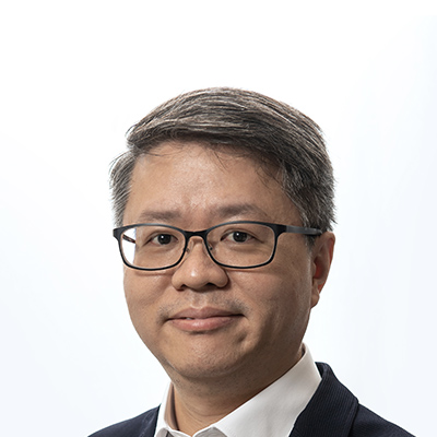 Headshot of a man with glasses and gray hair wearing a suit and white shirt