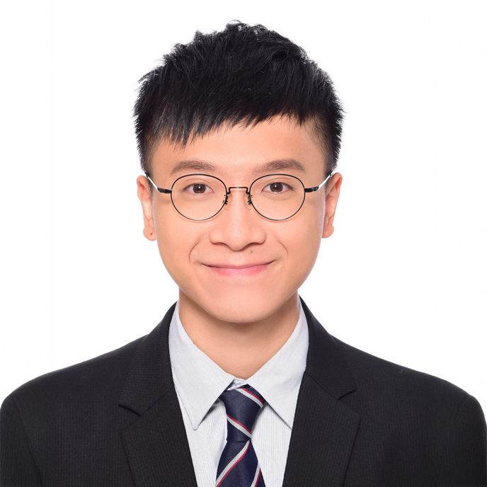 Portrait of a smiling man with glasses wearing a suit and tie.