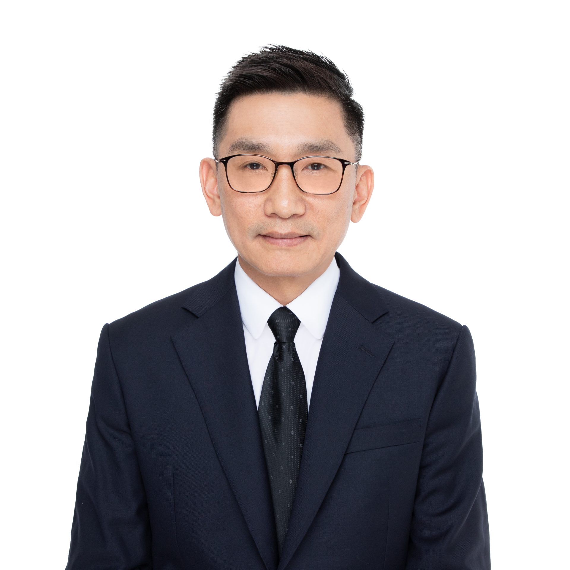 Man in dark suit and glasses against white background