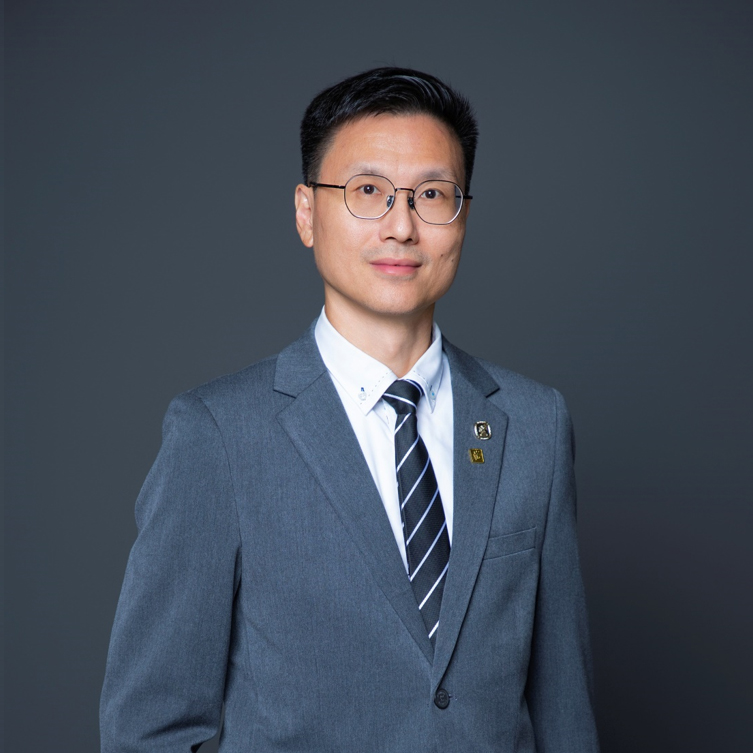 Man in gray suit and glasses, wearing striped tie and business attire.