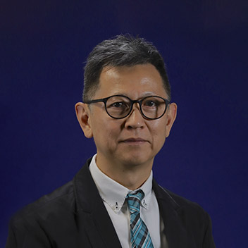 Man in suit and glasses against blue background