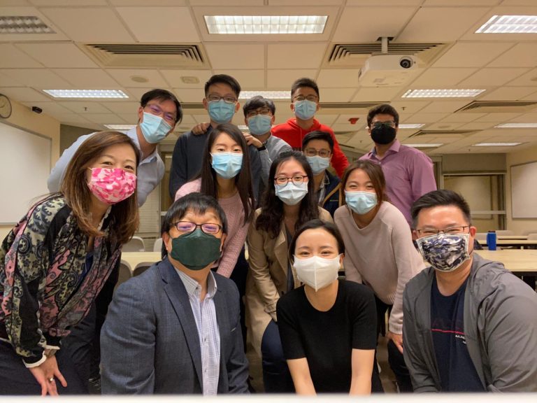Group photo of masked individuals in office setting, including named members and leadership.
