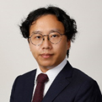 Portrait of a man with glasses wearing a suit and tie