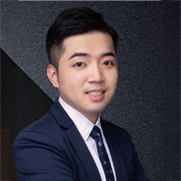 Professional headshot of a smiling man in business attire
