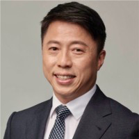 Portrait of Kenneth Chan Yiu Yeung, smiling in suit and tie