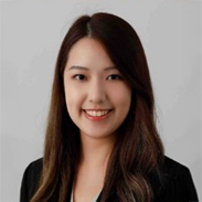 Portrait of Natalie Mak Hoi Lam, smiling with long brown hair against a neutral background.