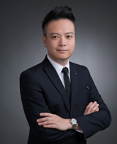 Chris Kwan in suit with arms crossed