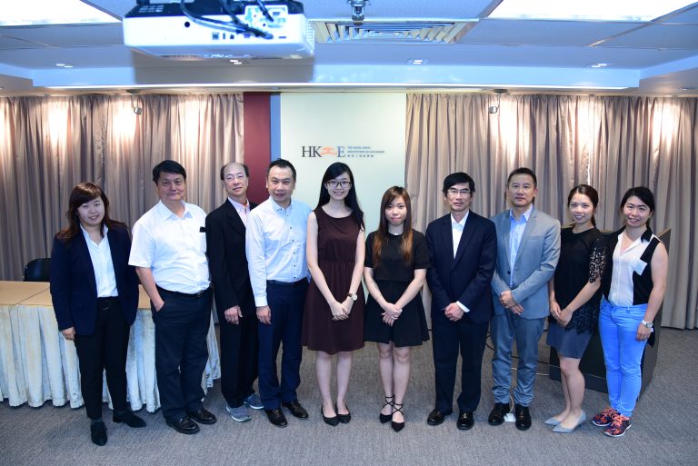Group of nine professionals posing for a photo in front of Hong Kong Institution of Engineers banner.