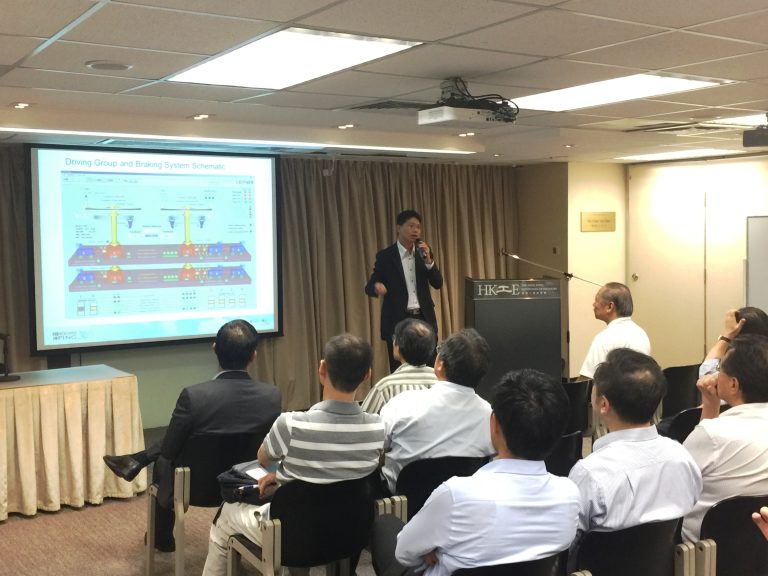 Engineer presenting driving and braking system schematic to audience at HKIE event