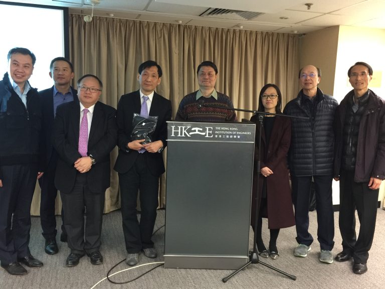 Group of seven professionals posing at a podium for The Hong Kong Institution of Engineers.