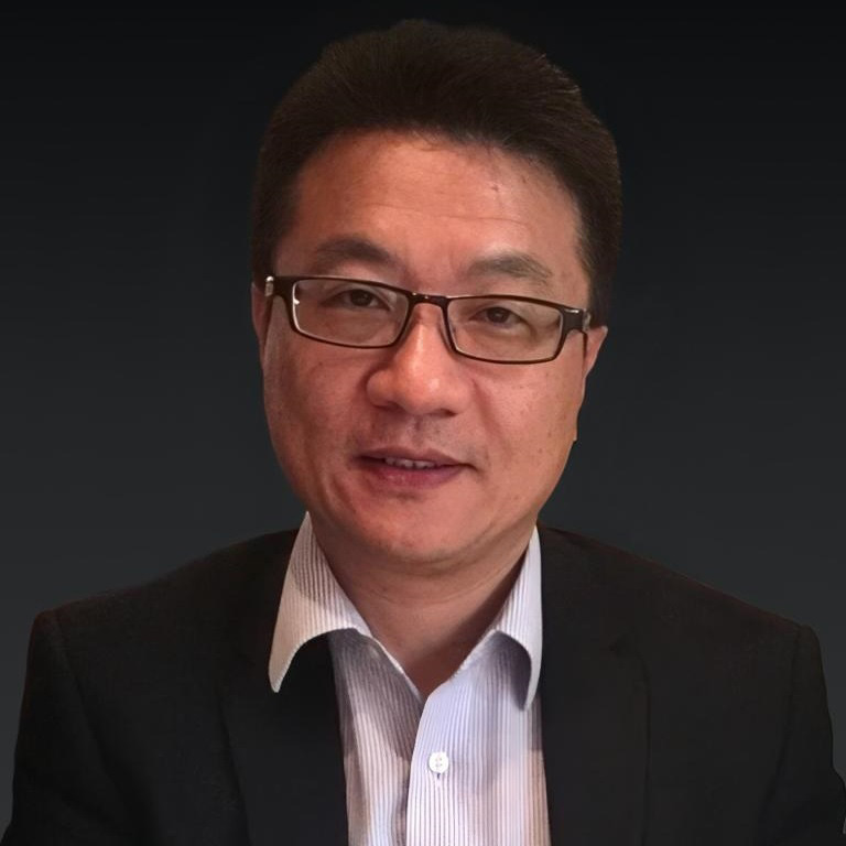 Portrait of Louis Lau wearing glasses and a suit jacket.