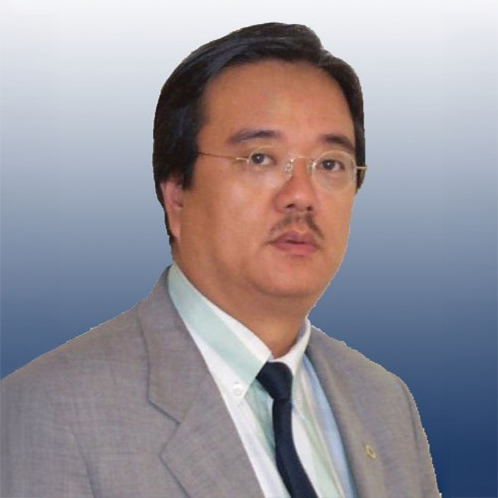 Portrait of a man in a suit and glasses against a blue gradient background.