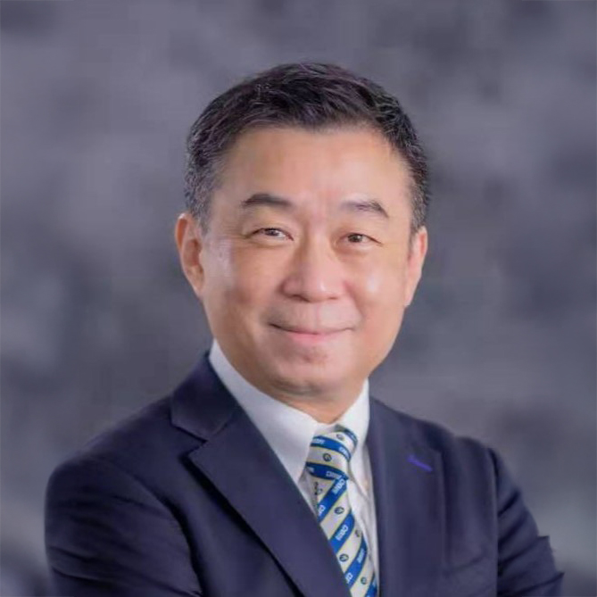 Professional headshot of John Chow in suit and tie, smiling against a gray background.