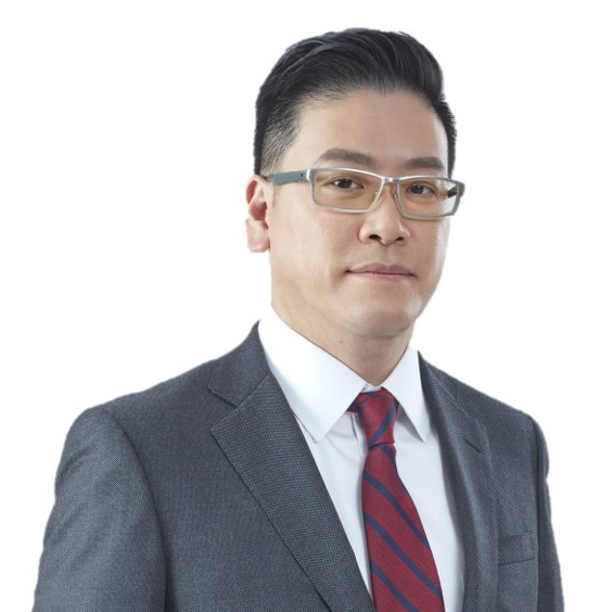 Portrait of Dr Kenneth Pak wearing glasses, suit, and striped tie.