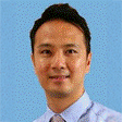Portrait of a smiling man in business attire against a blue background