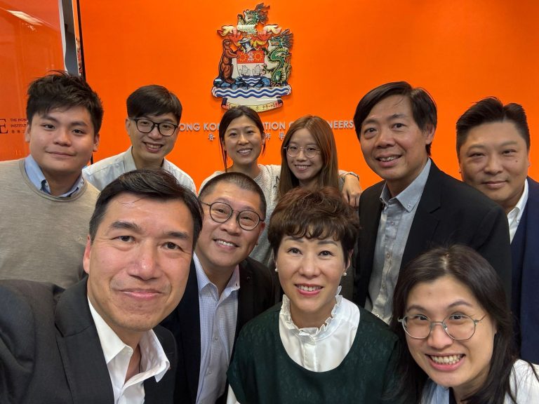 Group photo of smiling professionals in front of Hong Kong Institution of Engineers logo.