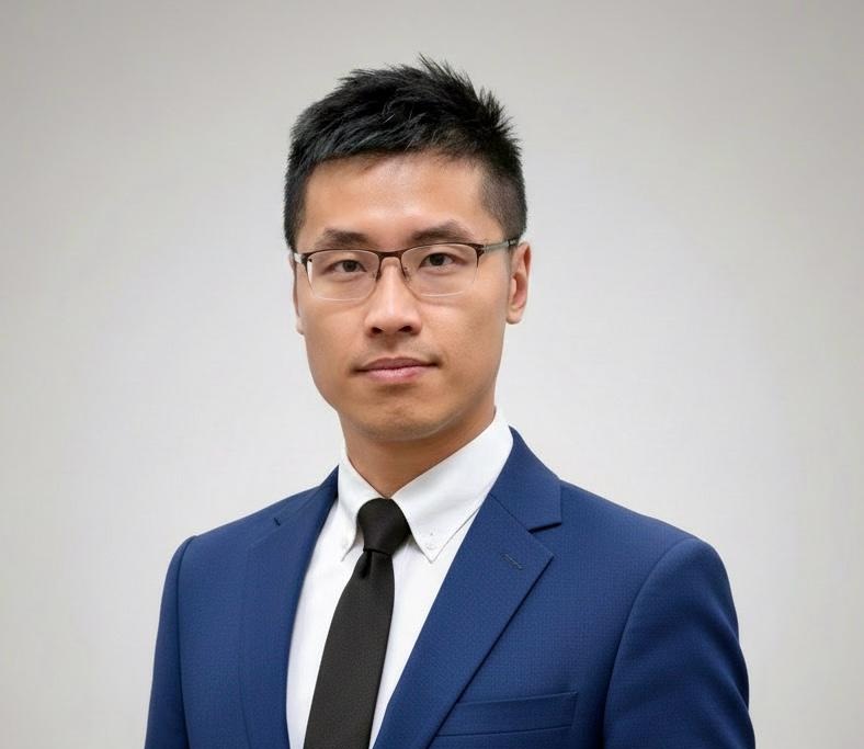 Man in blue suit and glasses, professional headshot