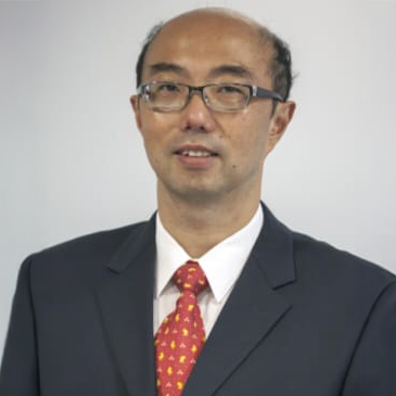 Portrait of CHAN Chi Kong wearing glasses, dark suit, and patterned red tie.