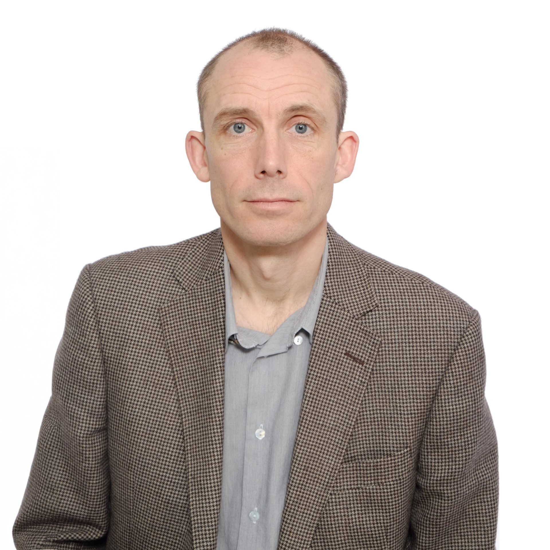 Portrait of Daniel Brown wearing a patterned blazer and collared shirt.