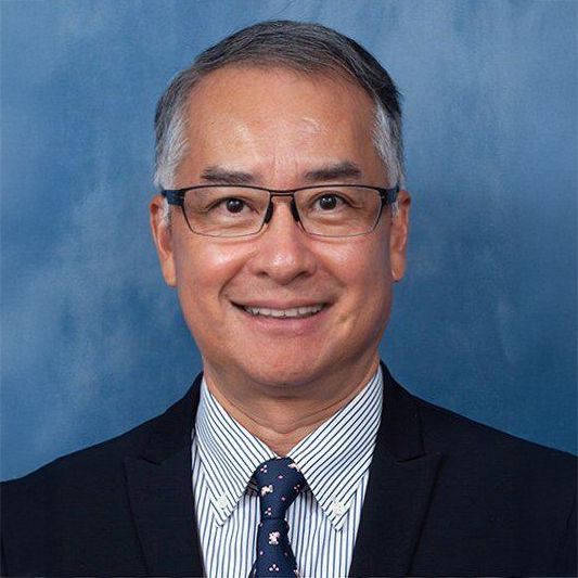 Portrait of Nigel CHEUNG Chuk Leung, smiling man in suit and glasses.