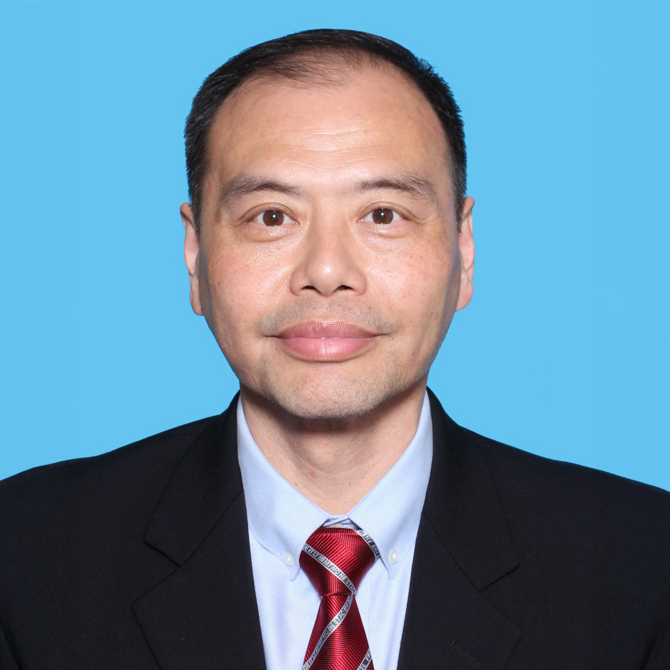 Otto MAK Wai Hung, man in suit and red tie, blue background