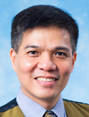 Portrait of a smiling man in business attire against a blue background