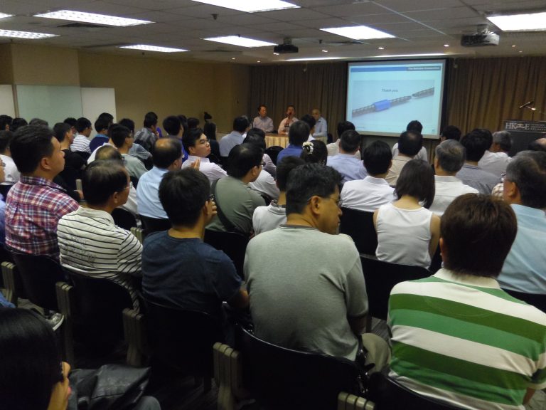 "Audience attending presentation with ""Thank you"" slide displayed on screen."