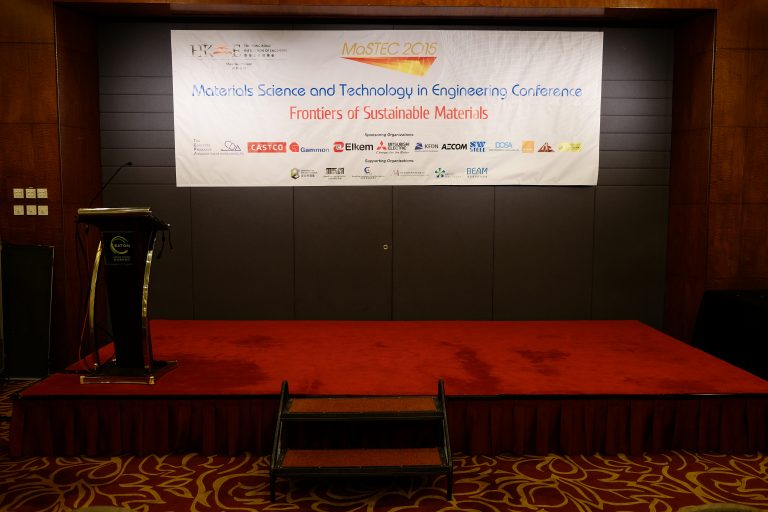 Conference stage with podium and banner for MaSTEC 2015 on sustainable materials.