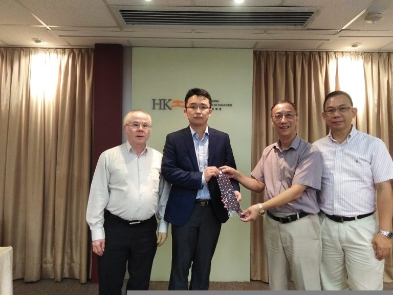 Four men at Hong Kong Institution of Engineers event, one receiving a patterned tie.