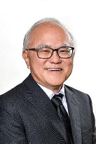 Smiling older man with glasses wearing a suit and tie