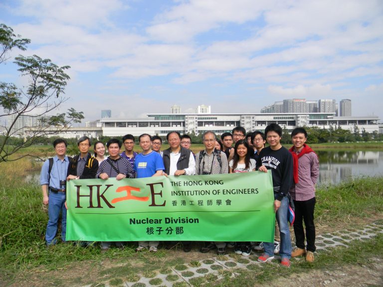 Group of engineers holding HKIE Nuclear Division banner at wetland location