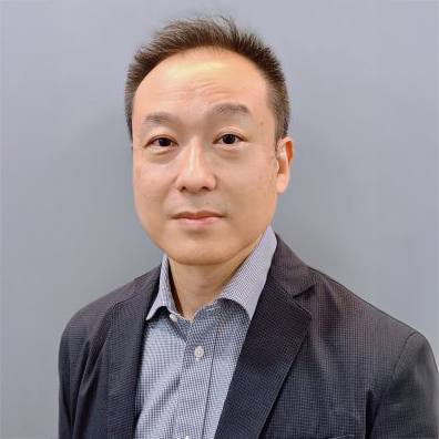 Portrait of a man with short dark hair wearing a suit jacket and collared shirt.
