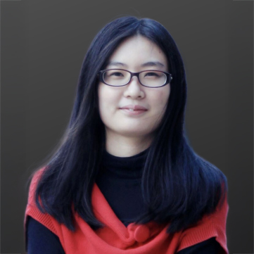 Portrait of a woman with glasses and dark hair wearing a red scarf.