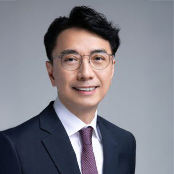 Portrait of Kevin Tang, Chairman, wearing glasses, suit, and tie.