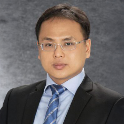 Professional headshot of a man in suit and glasses