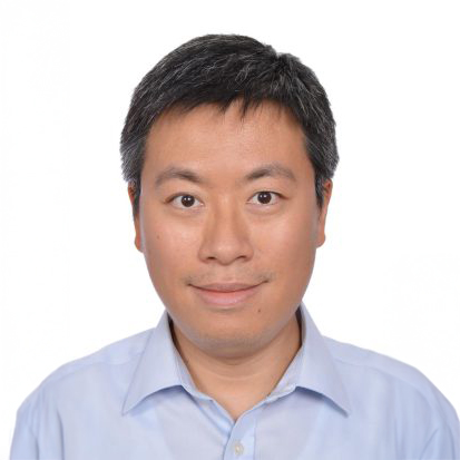 Portrait of a man with short dark hair wearing a light blue collared shirt.