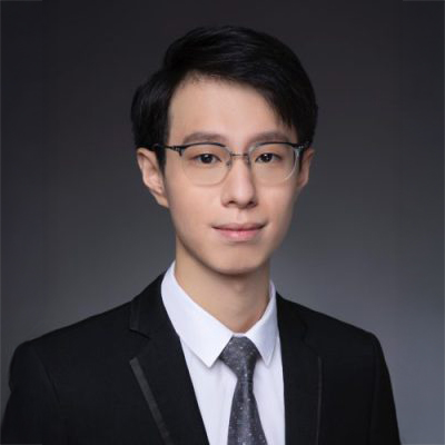Portrait of a man with glasses wearing a suit and tie.
