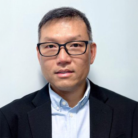 Portrait of a man with glasses wearing a suit jacket and collared shirt.