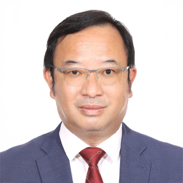 Man in suit and glasses, professional headshot against white background