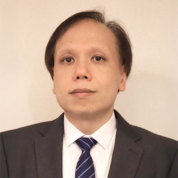 Portrait of a man in suit and tie looking at camera