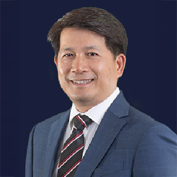 Professional headshot of a smiling man in suit and striped tie against dark blue background.